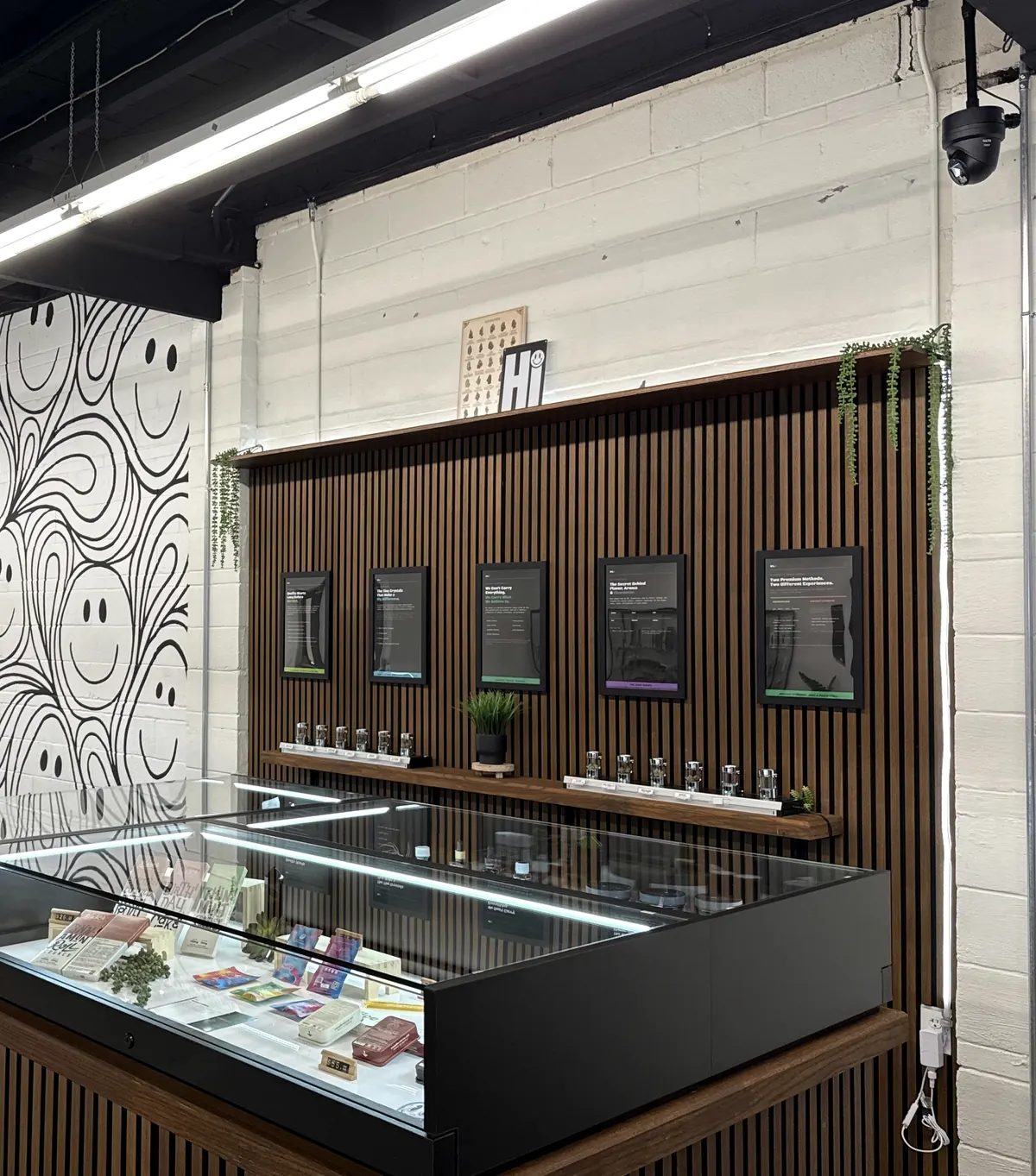 A wall of framed printed cards beside the display cases at White Label Exotics, each explaining a product category and why its chemistry matters.